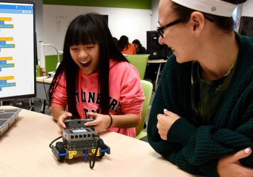 Little girl with VEX Robotics Machine